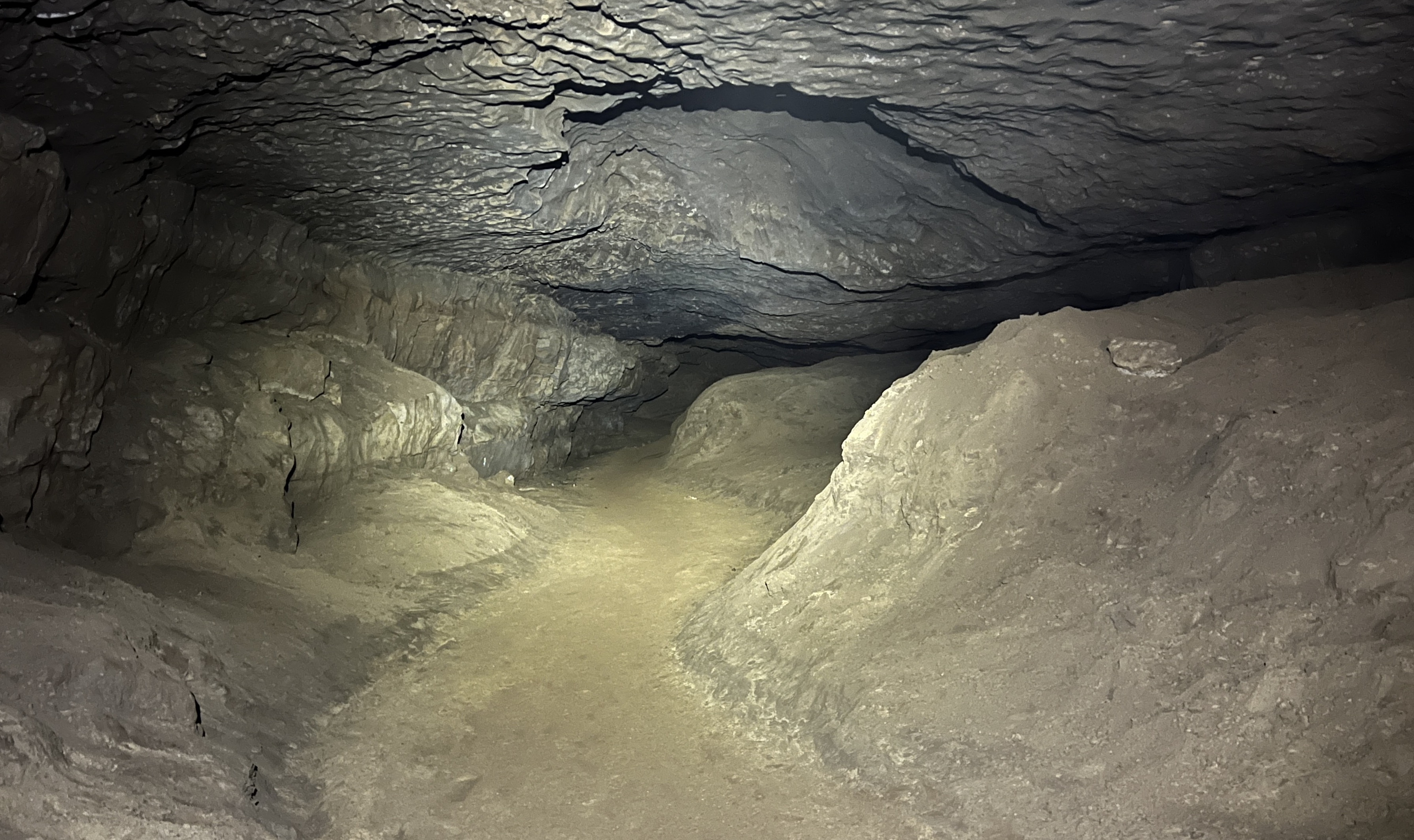 A dry, sandy passage within Duke St in Ireby Fell Cavern.
